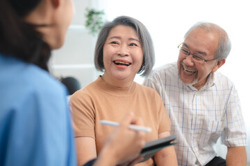 health insurance at home concept, happy Asian caregiver person support elderly patient in medicals...