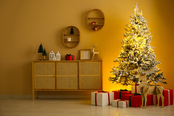 Stylish interior of modern living room with beautiful Christmas tree and gifts