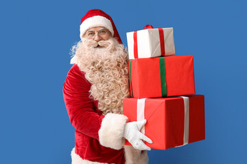 Santa Claus with Christmas gifts on blue background
