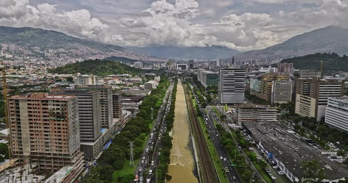 Medellin Colombia Aerial v13 flyover above river capturing heavy traffics and cityscape across Guayabal, Villa Carlota, Santa Fe and Alpujarra neighborhoods - Shot with Mavic 3 Cine - November 2022