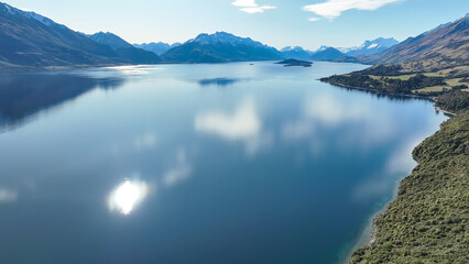 Dreamy aerial view from a mavic drone of the shoreline  of lake Wakatipu and its surrounding...