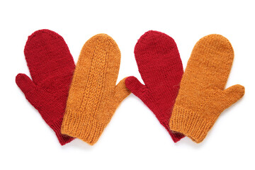 Warm knitted mittens on white background