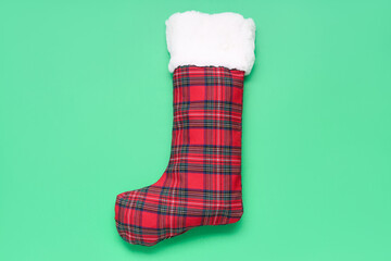 Christmas sock on green background
