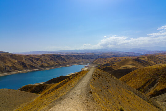 A deserted part of the Zaamin nature reserve in Uzbukistan on a sunny summer day. View of the mountains and reservoir.