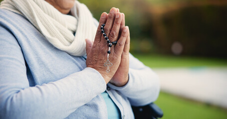 Senior, woman or hands praying with rosary for religion, worship and support for jesus christ in garden of home. Elderly, person and prayer beads for thank you, gratitude and trust in God for praise - obrazy, fototapety, plakaty