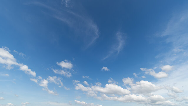  Panoramic view of clear blue sky and clouds, Blue sky background with tiny clouds. White fluffy clouds in the blue sky. Captivating stock photo featuring the mesmerizing beauty of the sky and clouds.
