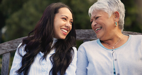 Happy, mature and mother with woman on bench, nature and bonding for laugh on retirement. Senior...