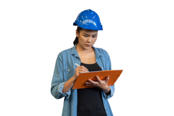 Portrait of female worker wearing safety uniform, helmet standing and working with clipboard on white background