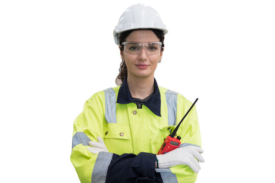Portrait of female engineer worker wearing safety uniform, helmet, gloves standing with crossed arms on white background