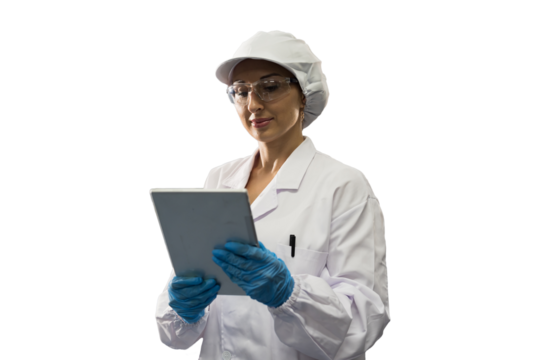 Portrait of female medical scientist wearing uniform, hairnet, gloves and working with digital tablet on white background
