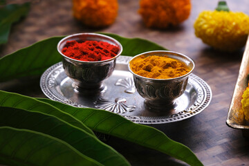 India's tradition Turmeric (Haldi) powder and kumkum powder in silver bowl for pooja. - obrazy, fototapety, plakaty