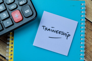 Concept of Traineeship write on sticky notes isolated on Wooden Table.