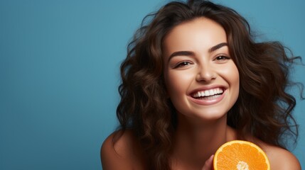 woman, portrait and orange for natural vitamin C, skincare or diet against a blue studio background.