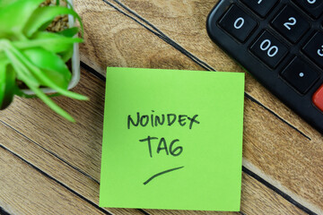 Concept of Noindex Tag write on sticky notes isolated on Wooden Table.
