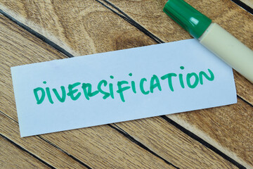 Concept of Diversification write on sticky notes isolated on Wooden Table.