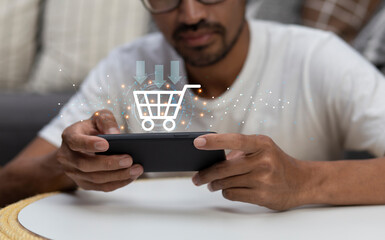man using smartphone with application online shopping platform and shopping cart icon during...