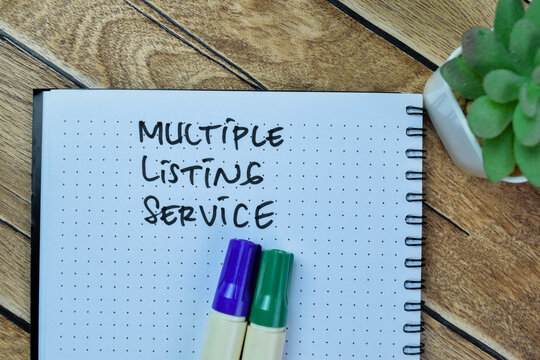 Concept of Multiple Listing Service write on book isolated on Wooden Table.