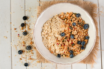 Porridge topped with granola and blueberries