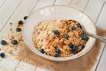 Porridge topped with granola and blueberries