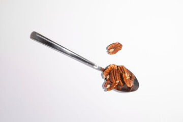 Pecan nuts in a spoon