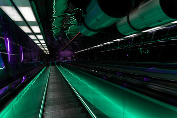 futuristic escalator stairs with neon green lights