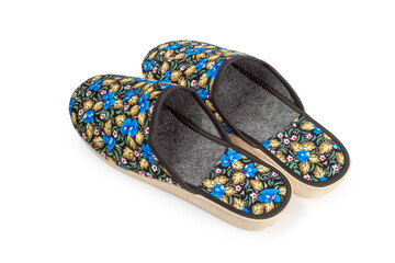 House slippers with floral pattern on white background. Close-up of slippers.