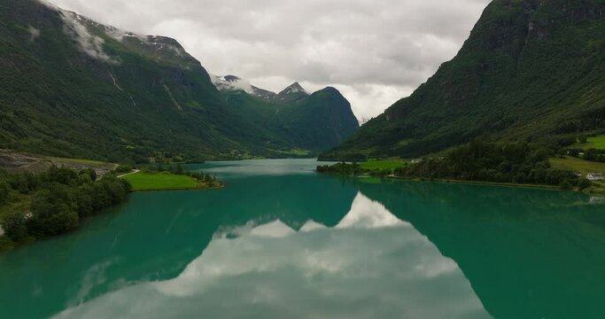 Scenic Oldevatnet glacier lake surrounded by imposing mountains, Norway. Aerial