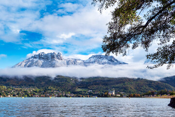 view of Annecy lake, autumn, snow on the mountain