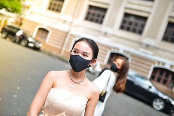 Young woman wearing sunglasses in city, colorful buildings and feel the warm. Exploring this bustling metropolis is a true adventure