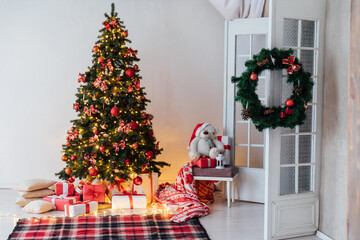 Christmas, New Year interior with red brick wall background, decorated fir tree with garlands and balls,