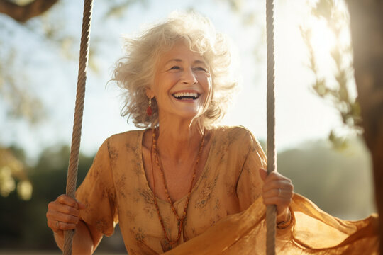 A portrait of a happy old woman with gray hair sitting on a rope wooden bench swing at the park. Generative AI.