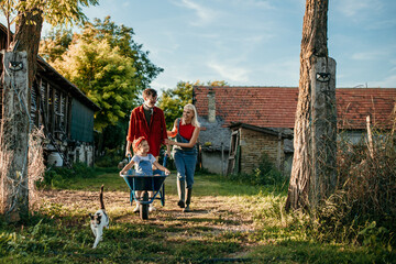 Shot of a man working his adorable wife and daughter on a farm