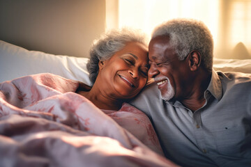 A loving dark-skinned elderly couple, a man and a woman, in bed in the morning. Love and romance of two people. Tenderness and relaxation. Happy morning for lovers. Valentine's Day. - obrazy, fototapety, plakaty