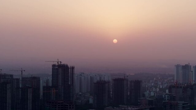 Aerial shot cityscape with buildings and  at dawn or dusk in Delhi, India. Development of real estate spaces in India.