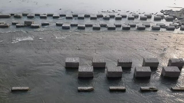 Concrete coastal wave blocker by the sindh river. square-shaped concrete coastal wave blocker. Beautiful view of pull dhole wali layyah pakistan. 4K Footage.