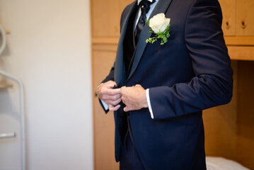 Elegant groom's jacket with a classic design, adorned with a stylish boutonniere, perfect for a sophisticated wedding ensemble