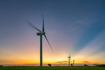 Panoramic view of wind farm or wind park, with high wind turbines for generation electricity with...