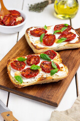 Ciabatta with sun-dried tomatoes, white cheese and basil. Italian food. Vegetarian food.