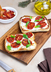 Ciabatta with sun-dried tomatoes, white cheese and basil. Italian food. Vegetarian food.