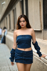 Young girl strolling down the street, stylish, timeless, youthful, modern, and dynamic fashion. Photo for a product targeting the younger generation, Gen Z, and specifically designed for active women