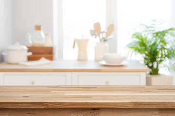 Empty wooden table for product display on blurred kitchen counter interior background - obrazy, fototapety, plakaty