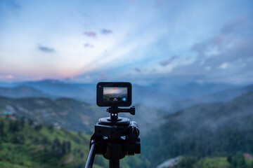 action camera on tripod in the mountains recording timelapse