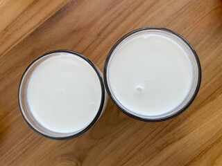 Two glasses of Ayran on the wooden table