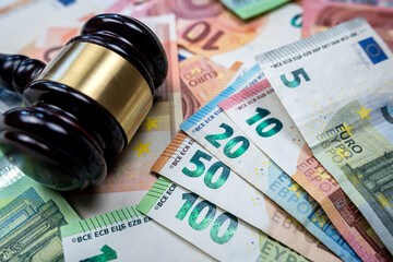 rule of law and auctions with judge's gavel and euro banknotes