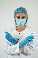Caucasian woman doctor in white uniform mask, gloves holding syringe with vaccine isolated on white