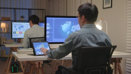 Asia people expert man tech talent night working late on predict sales insight SEO graph chart AI smart plan visual big data science report center BI tools screen. Office worker asian analyst job.