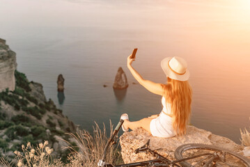 Selfie woman in cap and tank top making selfie shot mobile phone post photo social network outdoors on sea background beach people vacation lifestyle travel concept. - obrazy, fototapety, plakaty
