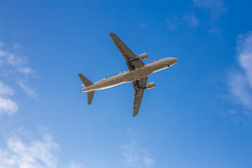 Passenger airplane. Low flying plane on the background of sky. Passenger Airplane Taking Off Into The Blue Sky. Linate Airport. Italia, Lombardia, San Donato Milanese