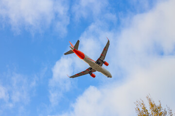 Passenger airplane. Low flying plane on the background of sky. Passenger Airplane Taking Off Into The Blue Sky. Linate Airport. Italia, Lombardia, San Donato Milanese