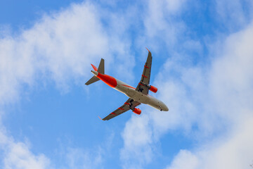 Passenger airplane. Low flying plane on the background of sky. Passenger Airplane Taking Off Into The Blue Sky. Linate Airport. Italia, Lombardia, San Donato Milanese